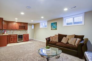 basement living room with kitchenette 