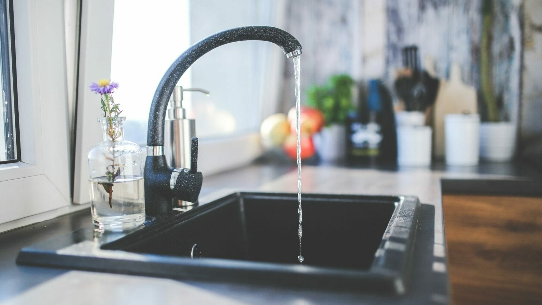 kitchen faucet pouring water.