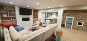 comfortable basement entertainment area with kitchenette attached